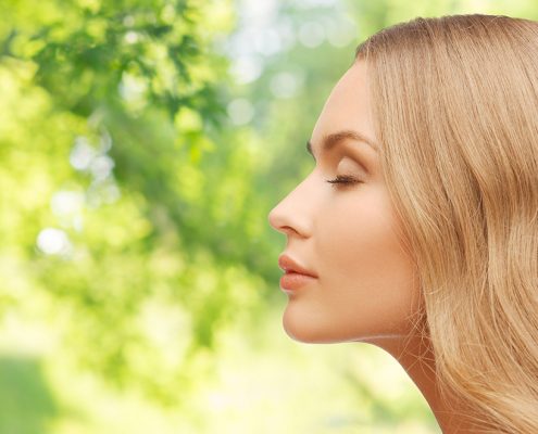 beautiful young woman face over natural background