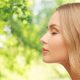 beautiful young woman face over natural background