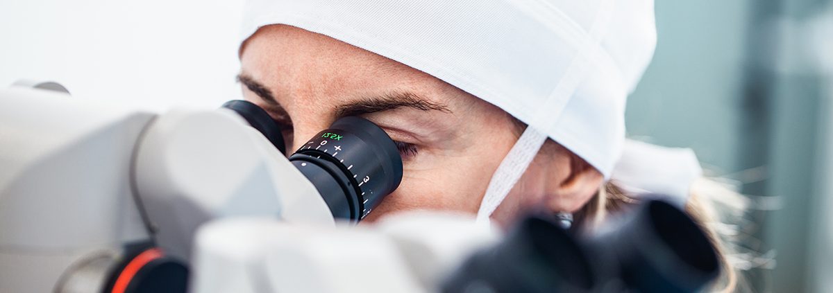 Doctor using microscope during eye surgery process, treatment of